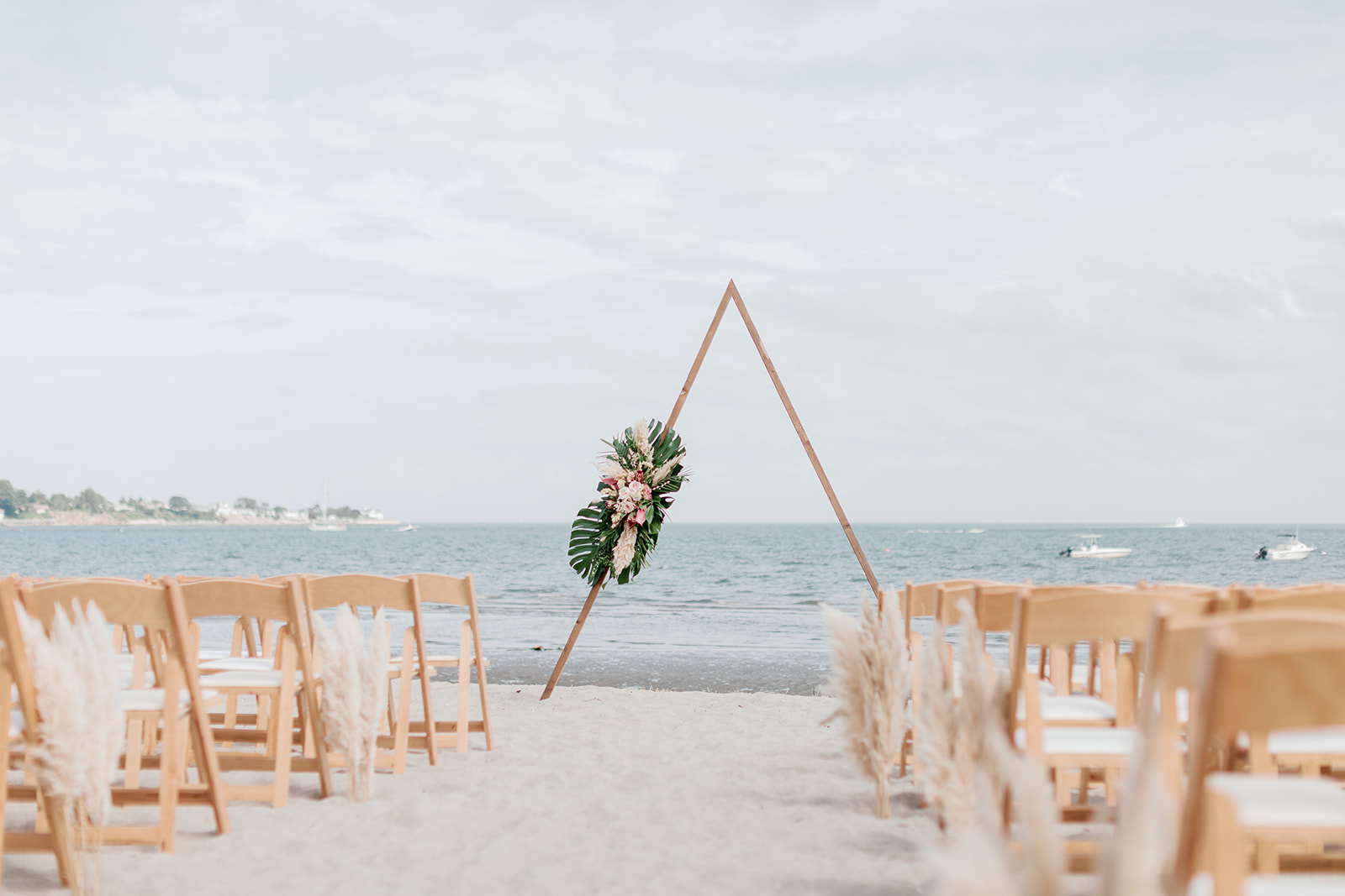 beach wedding with triangle arch