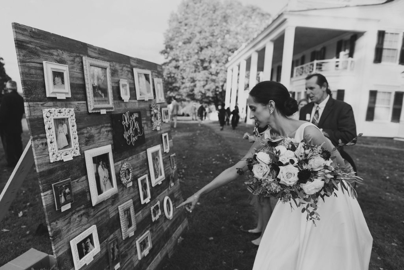 bride and groom pointing at wedding signage